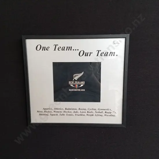 FRAMED COMMEMORATIVE PIECE CELEBRATING NEW ZEALAND TEAMS PARTICIPATION IN THE 2002 COMMONWEALTH GAMES IN MANCHESTER